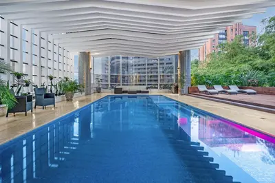 a large swimming pool in a building with a building at Stunning Luxury Penthouse with SPA and Concierge in Medellín