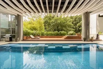 a swimming pool in a house with a building at Stunning Luxury Penthouse with SPA and Concierge in Medellín