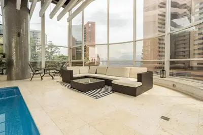 a living room with a couch and a pool at Stunning Luxury Penthouse with SPA and Concierge in Medellín