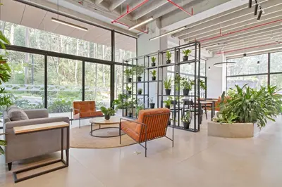 a lobby with chairs and tables and plants at Apartamento exclusivo, edificio moderno, gran balcon y linda vista in El Poblado