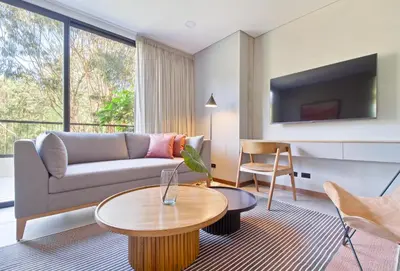 a living room with a couch and a table at Apartamento exclusivo, ideal para familias grandes con una vista sensacional in Medellín