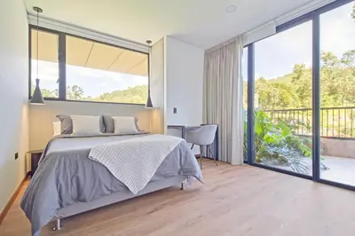 a bedroom with a bed and a large window at Apartamento exclusivo, ideal para familias grandes con una vista sensacional in Medellín