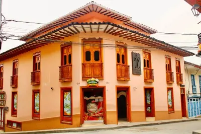 a building with wooden doors and windows on a street at Hotel Colonial Aguadas in Aguadas