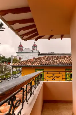 a balcony with a view of a building at Hotel Colonial Aguadas in Aguadas