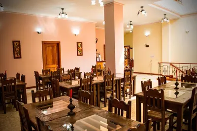 a restaurant with tables and chairs in a room at Hotel Colonial Aguadas in Aguadas