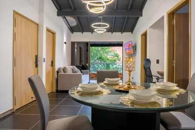 a dining room with a table and chairs at Modern Central Apt Laureles Medellin With 3 ACs in Medellín