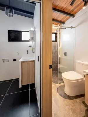 a bathroom with a toilet and a sink and a shower at Modern Central Apt Laureles Medellin With 3 ACs in Medellín
