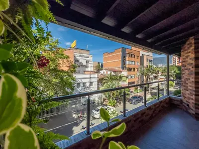 a balcony with a view of a city at Modern Central Apt Laureles Medellin With 3 ACs in Medellín