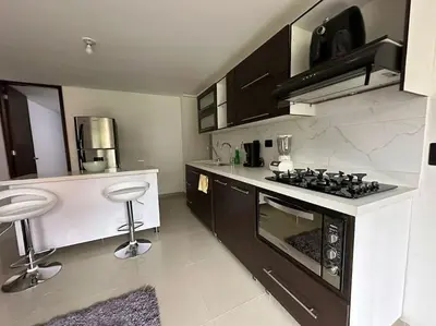 a kitchen with a stove and a counter top at Apartamento Nuevo Laureles- La 70 in Medellín