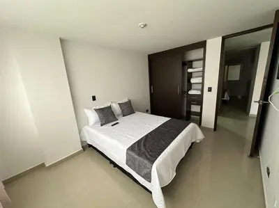 a bedroom with a large bed in a room at Apartamento Nuevo Laureles- La 70 in Medellín