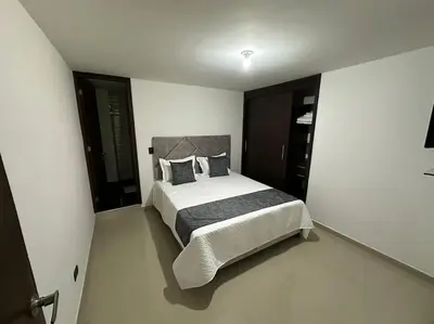 a bedroom with a large bed in a room at Apartamento Nuevo Laureles- La 70 in Medellín