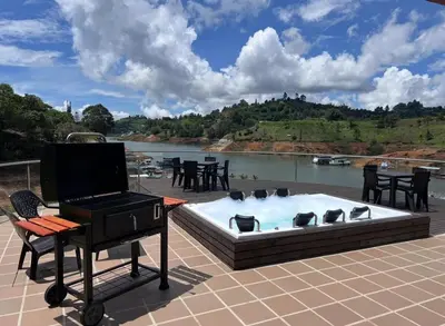 a pool with a grill and a piano on a patio at Finca con jacuzzi a 15min de Guatape in El Peñol