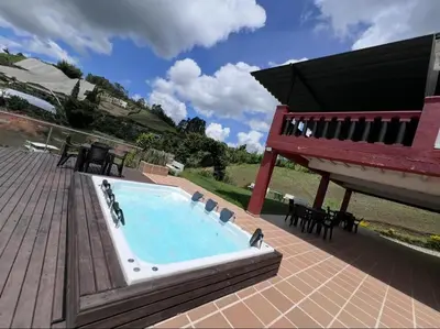 a swimming pool with a bench on a patio at Finca con jacuzzi a 15min de Guatape in El Peñol