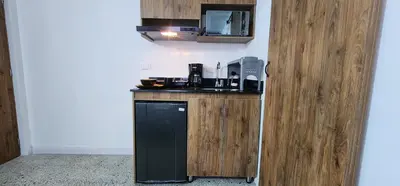 a kitchen with a sink and a microwave at Casa de las Palmas 1 in Medellín