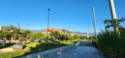 a walkway in a park with trees and grass at Casa de las Palmas 1 in Medellín