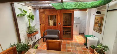 a hallway of a house with a chair and a refrigerator at Casa de las Palmas 1 in Medellín