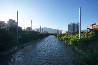 a river in the middle of a city with buildings at Casa de las Palmas 2 in Guayaquil