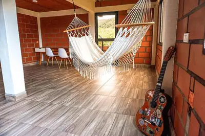 a room with two hammocks and a guitar at Retro Finca Urrao - Peaceful Avocado Farm Retreat in Urrao