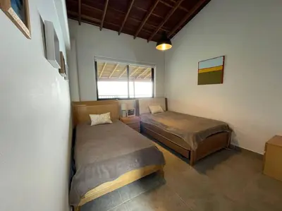 a bedroom with two beds and a window at Modern mountain house in Las Palmas