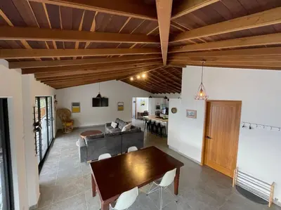 a living room with a table and a couch at Modern mountain house in Las Palmas