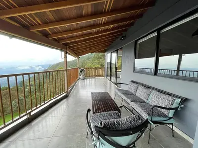 a balcony with a bench and a table and chairs at Modern mountain house in Las Palmas