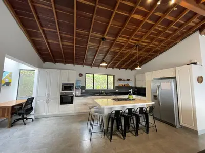 a kitchen with a island with bar stools at Modern mountain house in Las Palmas