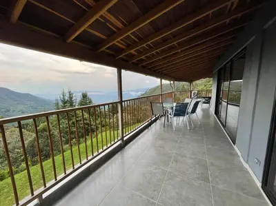 a balcony with a table and chairs on it at Modern mountain house in Las Palmas