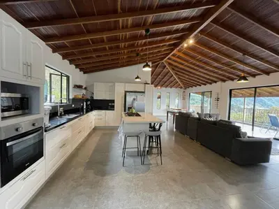 a kitchen and living room with a couch and a table at Modern mountain house in Las Palmas