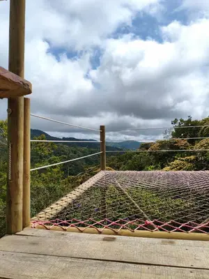 a wooden platform with a net on top of a hill at Finca AVALON Alejandria Antioquia in Alejandría