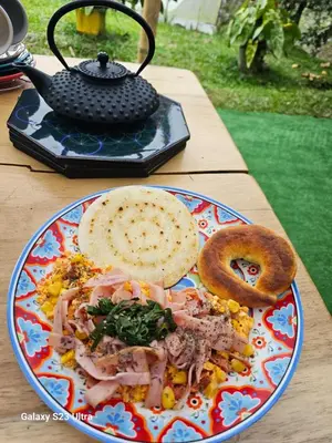 a plate of food on a table with a sandwich and bagel at Finca AVALON Alejandria Antioquia in Alejandría