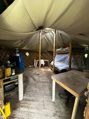 a room with a bed and a table in a tent at Cabaña en reserva natural in San Rafael