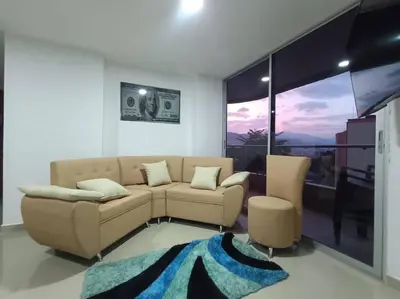 a living room with a couch and a large window at Comfortable Apt Envigado 3 Rooms 5 Beds in Envigado