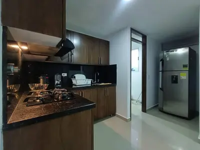 a kitchen with a stove and a refrigerator at Comfortable Apt Envigado 3 Rooms 5 Beds in Envigado