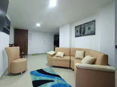 a living room with a couch and a dollar bill on the wall at Comfortable Apt Envigado 3 Rooms 5 Beds in Envigado