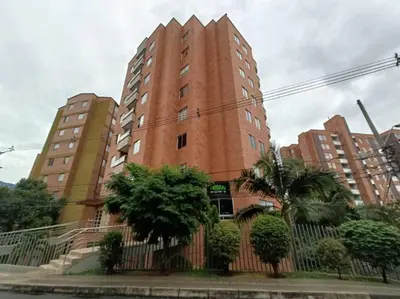 a tall brick building with trees in front of it at Comfortable Apt Envigado 3 Rooms 5 Beds in Envigado