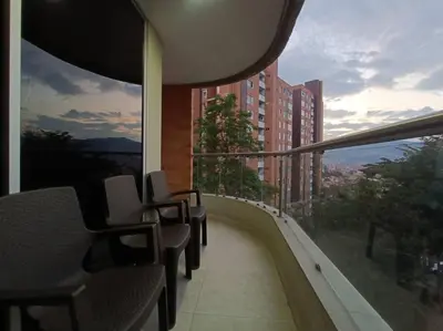 a balcony with chairs and a view of a building at Comfortable Apt Envigado 3 Rooms 5 Beds in Envigado
