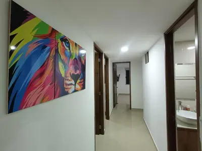a bathroom with a painting hanging on the wall at Comfortable Apt Envigado 3 Rooms 5 Beds in Envigado