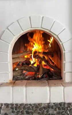 a brick oven with a fire in it at LasNubes EcolodgeNubes Ecolodge in Santa Elena