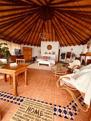 a large room with a bed and a table at LasNubes EcolodgeNubes Ecolodge in Santa Elena