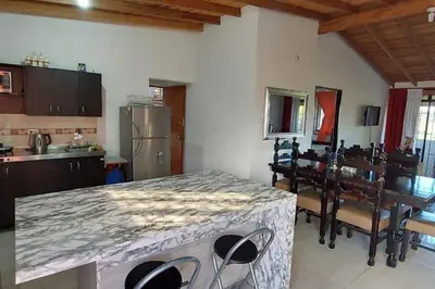 a kitchen with a table and chairs in a room at Casa de campo in Jericó