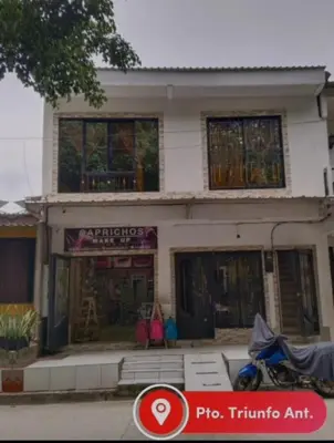 a house with a motorcycle parked in front of it at Apartamento Capri 1 in Puerto Triunfo