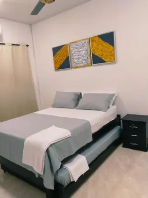 a bedroom with a bed and a painting on the wall at Apartamento Capri 1 in Puerto Triunfo