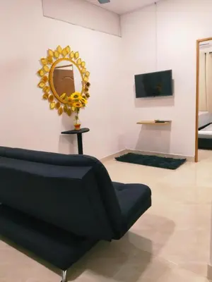 a living room with a couch and a mirror at Apartamento Capri 1 in Puerto Triunfo