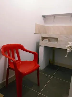 a red chair in a room with a desk at Apartamento Capri 1 in Puerto Triunfo