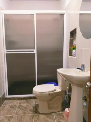 a bathroom with a shower and a toilet and a sink at Apartamento Capri 1 in Puerto Triunfo
