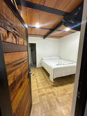 a room with a bed and a door with a bedroom at ECOHOTEL MONTEBELLO Norcasia Caldas in Confines