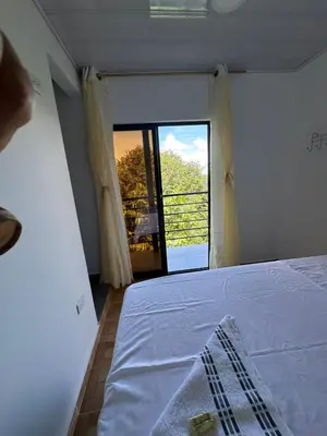 a bedroom with a bed and a large window at ECOHOTEL MONTEBELLO Norcasia Caldas in Confines