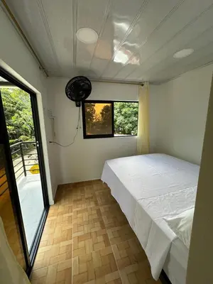 a bedroom with a white bed and a window at ECOHOTEL MONTEBELLO Norcasia Caldas in Confines