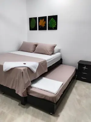 a bedroom with two beds with towels on them at Apartamento Capri 2 in Puerto Triunfo