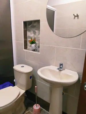 a bathroom with a toilet and a sink and a mirror at Apartamento Capri 2 in Puerto Triunfo